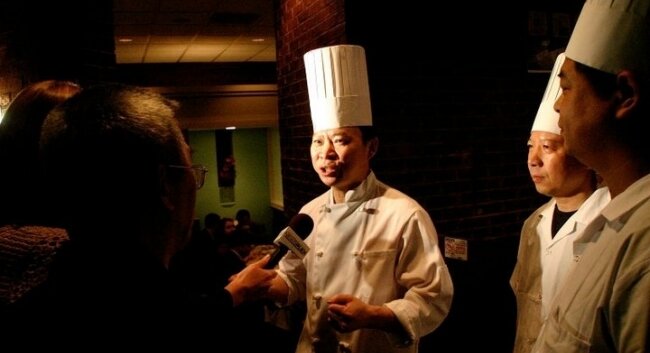 Peter Chang greets the media during the opening of his restaurant.
