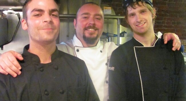 Chef Chris Humphrey (center) takes a bow with crew members Joe Garnett (left) and Eric Gondek.