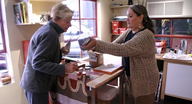 The spice diva herself, Phyllis Hunter (right), gives a customer a smell.