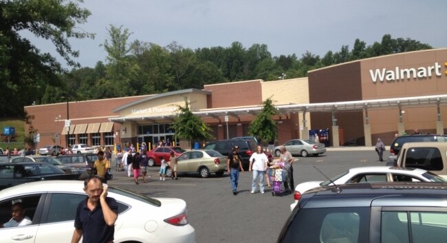 Shoppers at Wal-Mart exit the building.