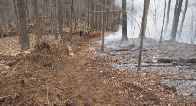This is what a bulldozer does: create a fire break line.