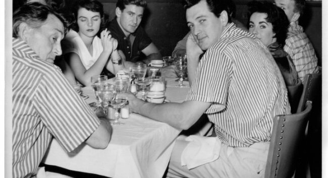 Roseberry surprises the cast at the Thomas Jefferson Inn: Hudson and Elizabeth Taylor at right, Rod Taylor center, and Paul Fix, best known as the marshal on The Rifleman, at left.