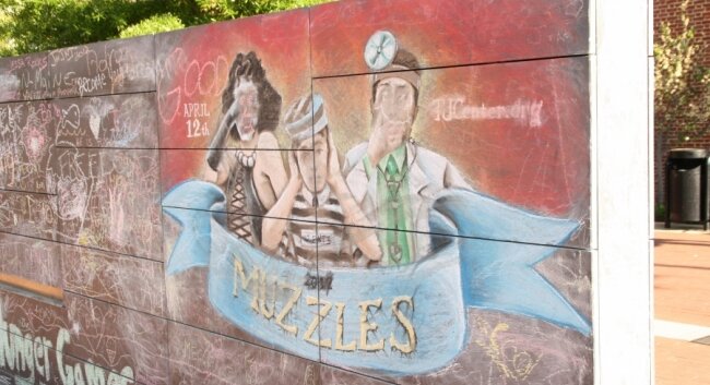 An artist chalked a Muzzle commemoration in front of City Hall on April 12.