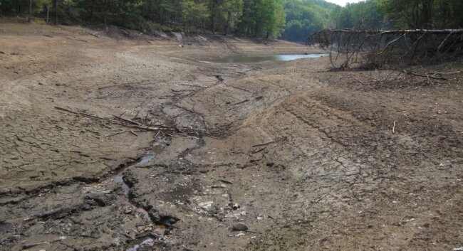 This cracked earth was, until recently, the bottom of the Ragged Mountain Reservoir, drained in anticipation of dam construction. Braverman notes that dredging requires no draining.
