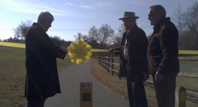 Albemarle County Supervisor Ken Boyd cuts the ribbon on the Old Mills Trail, a new 3-mile hike, bike, and walk trail on the eastern bank of the Rivanna River.