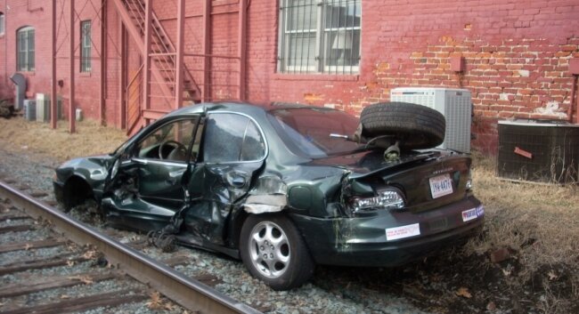 Are at-grade crossings safe? The driver of this car luckily walked away after a rendezvous with Amtrak%2526#039;s Cardinal at a downtown crossing in 2008.