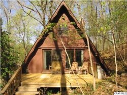 Quirkiest listing - Besides some severely angled walls, this 1BR, 1bath A-frame cottage featured a staircase leading to a sleeping loft with no closet and a bathroom doubling as a laundry room.