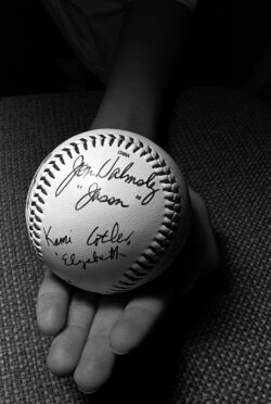 13-year-old Daniel Agnew of Richmond displays signatures of the stars. Why a baseball? Round parchment signatures last longer.