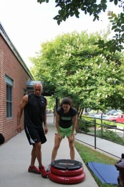Mahogany Smith instructs Leigh Wilkerson on the sidewalk outside of Club Mo Fitness.
