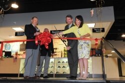 The attorney general helps cut the ribbon at the grand opening of Colonial Shooting Academy in the West End in April, 2012. 