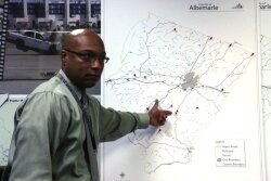Albemarle police spokesman Darrell Byers points to the map where pushpins mark the 19 fatalities on county roads so far this year.