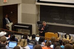 Terry McAuliffe speaks to a political science class at the University of Virginia in April as longtime professor Larry Sabato looks on.
