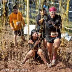 A woman lets out a yell as she%2526#039;s shocked by dangling electrified wires at last year%2526#039;s Wintergreen Tough Mudder.