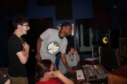 Damani Harrison, center, works on a radio program with CaTech students taking the Music Technology and Industry course he teaches.