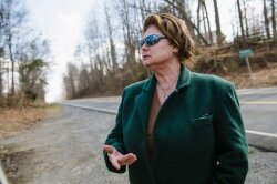 Cheri Durham Elliott, standing along the straightaway where the impact allegedly occurred, contends that her late father, the brother of the alleged accident witness, killed Pat Akins.