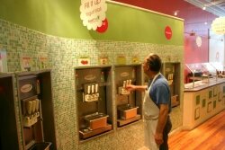 Co-owner of the Downtown Sweet Frog, Giovanni Sestito, inspects the soft-serve machines.