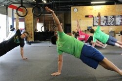 Scott Linton (left) leads a workout at CrossFit Charlottesville.