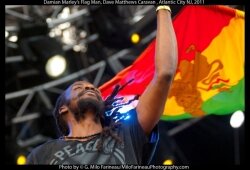 A flagman waves during Damian Marley%2526#039;s performance.