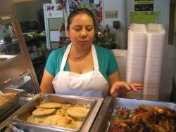 Maria Garcia explains that her chicken wings are roasted-- and spicy. She makes the gorditas stuffed with meat, cheese, and beans on the right, too. 