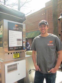 The Pie Guy, Justin Bagley, in front of his food cart.