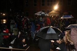 A crowd swarms at 10:18pm as prosecutor Dave Chapman reflects on the outcome.