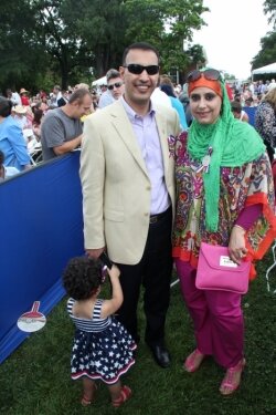 Originally from Baghdad, new U.S. citizens Haider Alsafee, his wife Zaimad, and their little girl.