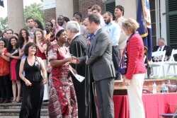 New citizens get their certificates of citizenship, and handshakes and hugs from The Dave. 