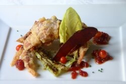 Soft-shell crab, cooked tempura style, with fried green tomatoes, a crispy speck, and tomato relish.