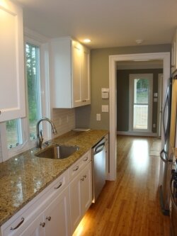 Pullman kitchen with granite countertops and stainless appliances