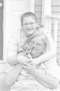 Meghan Bambrey (top) with mom Kathy and their two-month-old Jack Russell, Kizzy.