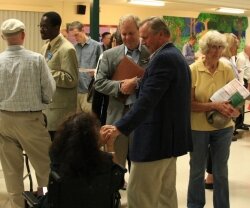 Southern Environmental Law Center%2526#039;s Rick Middleton looks on as John Grisham greets a citizen. 
