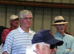 The striped-shirted man who cast the winning $1.9 million bid still has not been identified. On the right is Chris Lee of Piedmont Development Group, which had been working on the rezoning. 