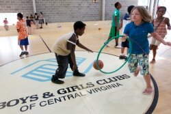 Kayewon Brown, 9 1/2, of Charlottesville, dribbles while Audrianna Hinton, 10, of Ruckersville, moves a hula hoop.