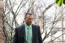 Albemarle County Police Officer Andrew D. Holmes, pictured here leaving Albemarle District Court in March, was convicted of improper driving for an October 2011 accident. The conviction was upheld on appeal.