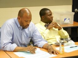 Wes Bellamy, right, with adviser Ty Cooper, waits to hear his fate in the six provisional ballots about to be counted.