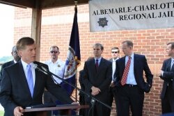 Governor Bob McDonnell goes to the regional jail to get tough on child rapists and sign bills by state Senator Mark Obenshain and Delegate Rob Bell, standing right of the flag.