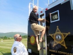 Sheriff Chip Harding checks out the observation deck on the new mobile command trailer, while Lieutenant Tom Payne is ready for a rescue if the sheriff slips.