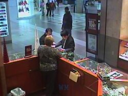 This still from the mall security video helped lead to the arrest of James Kevin Key (standing in the background wearing a sweatshirt or hooded jacket).