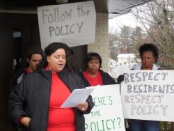 Public Housing Association of Residents chair Latita Owens-Talbert reads a statement denouncing the housing authority.