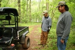 At the scene of the attack: Thompson and Bryant examine the rear bed of the Gator where the bear was shot. WARNING: Next photo is graphic.