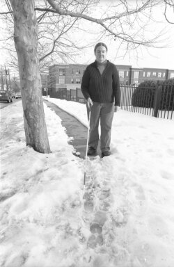 Pedestrian Sarah Pool tries to negotiate a city sidewalk apres les snows.