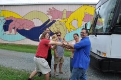 The deal is sealed: Fabian Kuttner, Andre Ferreira (brother of A Goff), mural artist Ross McDermott, Ana Regina Goff and Dan Goff shake on the Starlight%2526#039;s new location. 