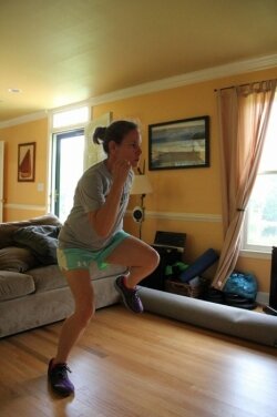 Following the DVD instructions, Nica Waters works out in her living room.