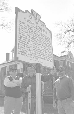  Julian Aylor, Lloyd Clatterbuck, and Tony Utz put the finishing touches on Charlottesville’s newest historic landmark sign. 