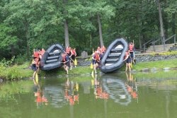 Members of SEAL Team Physical Training prepare for a morning of rafting.