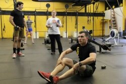 Michael Towne demonstrates an exercise at Solidarity CrossFit.